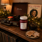 Load image into Gallery viewer, A cozy holiday tabletop scene with a vintage-style record player, a 16 oz mason jar candle  labeled 'Fireside Magic', a Bing Crosby Christmas Classics album cover, a lamp, evergreen garland with warm lights, and gingerbread cookies on a plate. Southern Charm Farmhouse
