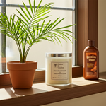 Load image into Gallery viewer, Hawaiian Tropic 2 wick hand poured candle and bottle on a windowsill with a plant and sunscreen. Southern Charm Farmhouse.
