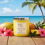Load image into Gallery viewer, Yellow 2 Wick candle labeled 'Jamaica Me Crazy' on a wooden surface with tropical fruits and flowers, beach in the background. Southern Charm Farmhouse.
