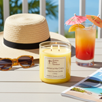 Load image into Gallery viewer, 2 wick hand poured candle on a balcony with a tropical drink, sun hat and sunglasses beside it. Southern Charm Farmhouse.
