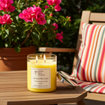 Load image into Gallery viewer, 2 wick hand poured Jamaica Me Crazy candle on an outdoor wooden table with a sun chair and flowers in the background. Southern Charm Farmhouse.
