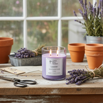 Load image into Gallery viewer, 2 wick hand poured Lavender candle on a wooden surface with lavender flowers and pots in the background. Southern Charm Farmhouse.
