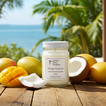Load image into Gallery viewer, Mango Coconut hand poured candle with mangoes and coconuts on a wooden surface with a beach background. Southern Charm Farmhouse.
