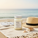 Load image into Gallery viewer, 16 oz hand poured mason Jar of Mango Coconut candle on a beach with a hat, shells, and sandals. Southern Charm Farmhouse.
