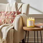 Load image into Gallery viewer, 2 wick hand poured Mango Coconut Candle on a side table next to a cozy armchair with a blanket and pillow. Southern Charm Farmhouse.
