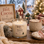Load image into Gallery viewer, A lit glass jar candle labeled 'Marshmallow Wonderland' by Southern Charm Farmhouse, styled on a wooden table with a cozy holiday scene including a mug of marshmallows and hot cocoa, candy canes, a knit blanket, and a sign reading 'Hot Cocoa &amp; Warm Wishes'.

