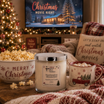 Load image into Gallery viewer, A cozy holiday scene with a hand-poured candle labeled 'Marshmallow Wonderland' centered in front of a TV that reads 'Christmas Movie Night.' A bowl of popcorn with 'Merry Christmas' text, a mug with marshmallows and a red truck, and a plaid blanket create a warm festive setting. Southern Charm Farmhouse.

