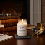 Load image into Gallery viewer, 16 oz Hand Poured Candle labeled 'Midsummer's Night' on a table with books, glasses, and a compass. Southern Charm Farmhouse.
