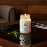 Load image into Gallery viewer, 16 oz Hand Poured Candle in a glass jar labeled 'Midsummer's Night' on a reflective surface with a blurred background. Southern Charm Farmhouse.
