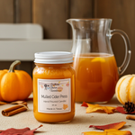Load image into Gallery viewer, 16 oz mason Jar of 'Mulled Cider Press' candle with a pitcher of mulled cider and pumpkins on a table. Southern Charm Farmhouse.
