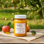 Load image into Gallery viewer, 16 oz mason Jar of 'Mulled Cider Press' candle with apples on a wooden surface outdoors. Southern Charm Farmhouse.
