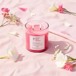 Load image into Gallery viewer, Pink Sands Candle with 2 wicks in a clear glass jar on a pink sand surrounded by flowers. Southern Charm Farmhouse.



