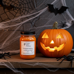 Load image into Gallery viewer, Pumpkin Hollow hand poured candle and carved pumpkin on a Halloween-themed background with cobwebs and bats. Southern Charm Farmhouse.
