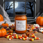 Load image into Gallery viewer, Pumpkin Hollow hand poured  candle with Halloween-themed decorations on a wooden surface. Southern Charm Farmhouse.
