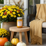 Load image into Gallery viewer, Autumn-themed outdoor setting with pumpkins, flowers, and a 16 oz mason jar hand poured Pumpkin Pickin candle on a small table.  Southern Charm Farmhouse.
