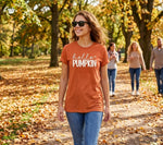 Load image into Gallery viewer, Woman wearing an 'hello PUMPKIN' shirt in a park with autumn leaves. Southern Charm Farmhouse. 
