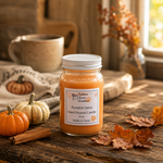 Load image into Gallery viewer, A 16 oz mason jar candle labeled 'Pumpkin Spice Hand Poured Candle' sits on a rustic wooden table surrounded by autumn props including small pumpkins, leaves, cinnamon sticks, and a mug in the background. Southern Charm Farmhouse.
