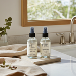 Load image into Gallery viewer, One 4 oz room spray and One 4 oz Linen bottle on a kitchen counter with a window in the background. Southern Charm Farmhouse.
