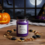 Load image into Gallery viewer, 16 oz mason jar Purple hand poured candle labeled 'Spellbound' on a wooden surface with Halloween decorations. Southern Charm Farmhouse.
