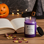 Load image into Gallery viewer, 16 oz mason jar Purple hand poured candle labeled 'Spellbound' on a wooden surface with Halloween decorations. Southern Charm Farmhouse.
