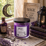 Load image into Gallery viewer, A purple wax hand poured candle labeld Spellbound in a clear glass jar with a black lid sits on a rustic table surrounded by witch-themed props, including a lantern, old books, lavender, a small bottle labeled Witch's Brew, and a framed sign that reads 'Magic is always a good idea.'. Southern Charm Farmhouse.
