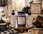 Load image into Gallery viewer, Three Spellbound scented products from Southern Charm Farmhouse are displayed on a rustic wood slice tray. The set includes one clear glass room spray bottle and one clear glass linen spray bottle with black atomizers and a central purple 16 oz mason  jar candle with a black lid labeled Spellbound.
