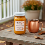 Load image into Gallery viewer, Jar of spiced rum pumpkin hand poured candle on a wooden surface with a copper mug. Southern Charm Farmhouse.
