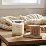 Load image into Gallery viewer, 2 wick hand poured Sweet Vanilla Caramel Candle and steaming mug on a wooden table with a blanket in the background. Southern Charm Farmhouse.

