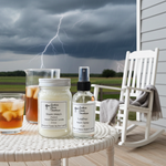 Load image into Gallery viewer, 16 oz Mason Jar Storm Watch hand poured candle and one Leather Room Spray of Southern Charm products on a table with a stormy sky and lightning in the background. Southern Charm Farmhouse.

