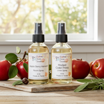 Load image into Gallery viewer, One room spray and One Linen Spray bottle on a wooden surface with apples and leaves.  Southern Charm Farmhouse.
