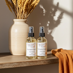 Load image into Gallery viewer, One bottle of Pumpkin Spice room spray and one bottle of Pumpkin Spice Linen Spray on a wooden shelf with a vase and towel in the background.  Southern Charm Farmhouse.

