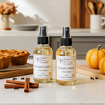 Load image into Gallery viewer, Two bottles of pumpkin-themed room and linen spray on a kitchen counter with pumpkins and cinnamon sticks.  Southern Charm Farmhouse.
