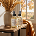 Load image into Gallery viewer, Two bottles of pumpkin spice-themed room and linen spray on a wooden table with autumn decor.
