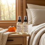 Load image into Gallery viewer, One bottle of pumpkin spice room spray and one bottle of pumpkin spice linen spray on a nightstand next to a bed with pillows.  Southern Charm Farmhouse.
