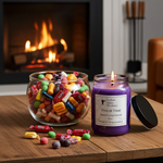 Load image into Gallery viewer, Purple hand poured candle with a label Trick or Treat and a jar of colorful candies on a wooden surface in front of a fireplace. Southern Charm Farmhouse.
