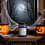 Load image into Gallery viewer, Halloween-themed hand poured Twilight Woods candle with jack-o'-lanterns and spider webs on a wooden surface. Southern Charm Farmhouse.

