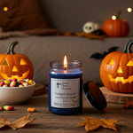 Load image into Gallery viewer, Hand Poured Candle labeled 'Twilight Woods' with Halloween decorations including pumpkins and candy on a wooden table. Southern Charm Farmhouse.
