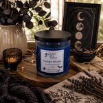 Load image into Gallery viewer, A blue wax candle in a clear glass jar with a black lid sits on a wooden tray in a styled tabletop scene. The label reads 'Twilight Woods' and 'Southern Charm Farmhouse.
