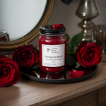 Load image into Gallery viewer, Hand Poured Candle labeled 'Vampire's Blood' surrounded by red roses on a wooden surface. Southern Charm Farmhouse.

