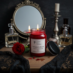 Load image into Gallery viewer, Red hand poured candle labeled 'Vampire's Blood' with perfumes and a rose on a dark background. Southern Charm Farmhouse.
