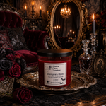 Load image into Gallery viewer, A red wax hand poured candle in a clear glass jar with a black lid sits on an ornate silver tray in a dark, gothic room. The label reads ' Vampire's Blood Hand Poured Candle 2 Wick'. Southern Charm Farmhouse.
