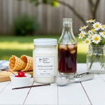 Load image into Gallery viewer, Vanilla ice cream hand poured candle with waffle cones, cherry, and iced coffee on a table outdoors. Southern Charm Farmhouse
