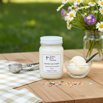 Load image into Gallery viewer, 16 oz Mason jar Vanilla ice cream hand poured candle with a bowl of ice cream and flowers on a wooden table outdoors. Southern Charm Farmhouse
