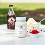 Load image into Gallery viewer, 16 oz Mason Jar Vanilla ice cream hand poured candle with a cherry on top, vanilla syrup bottle, and ice cream in the background. Southern Charm Farmhouse.
