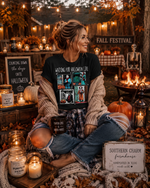 Load image into Gallery viewer, Woman sitting at a fall festival with Halloween-themed decorations and candles. Southern Charm Farmhouse.
