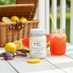 Load image into Gallery viewer, 16 oz Mason jar hand poured Candle labeled 'Watermelon Lemonade' on a picnic table with lemons, sunglasses, and a drink. Southern Charm Farmhouse
