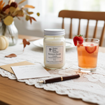 Load image into Gallery viewer, Baccarat Rouge 540 Candle, 16 oz Mason Jar, glass of pink drink with strawberry, and stationery on a lace tablecloth.
