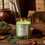 Load image into Gallery viewer, Green hand poured candle labeled 'Cedar &amp; Autumn Leaves' on a wooden surface with natural elements.  Southern Charm Farmhouse.
