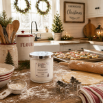 Load image into Gallery viewer, A lit scented candle labeled 'Christmas Cookie' sits on a rustic kitchen counter surrounded by baking props, including flour, cookie cutters, a rolling pin, a flour canister, and decorated cookies in the background. Southern Charm Farmhouse.
