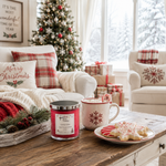 Load image into Gallery viewer, A festive holiday living room scene with a red hand poured Candy Cane candle in a glass jar on a wooden coffee table, next to a pink mug with a candy cane and decorated cookies. The room features a decorated Christmas tree, cozy armchairs, and a white sofa with 'Merry Christmas' pillows. Southern Charm Farmhouse.
